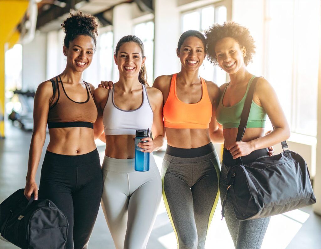 Group of women laughing and smiling getting ready to go gym 